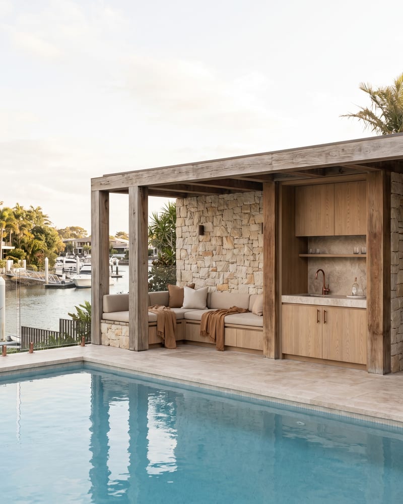 Poolside cabana with built-in timber and stone joinery